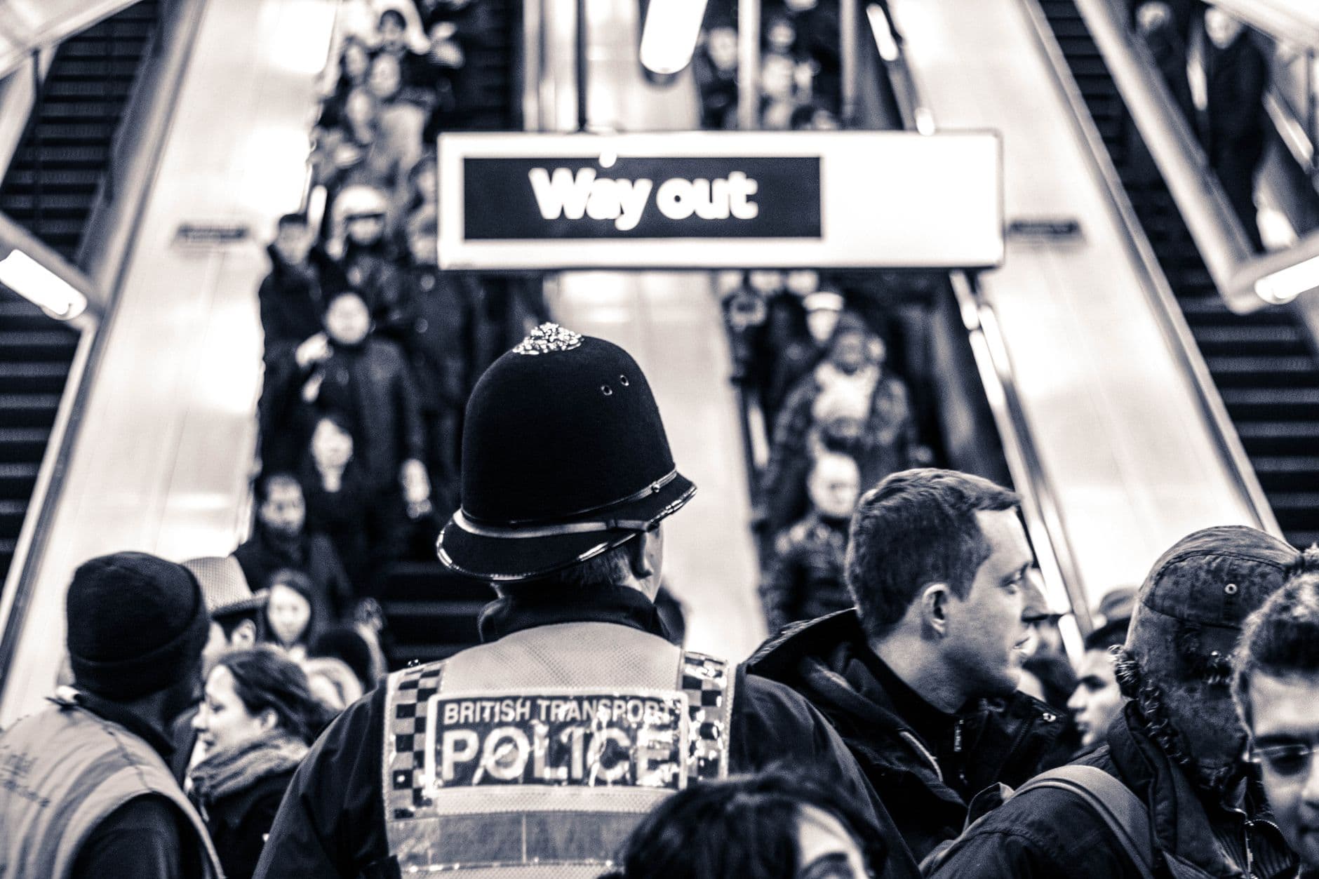 British Transport Police monitor a busy crowd in London Underground. Urban safety and public transit concept.