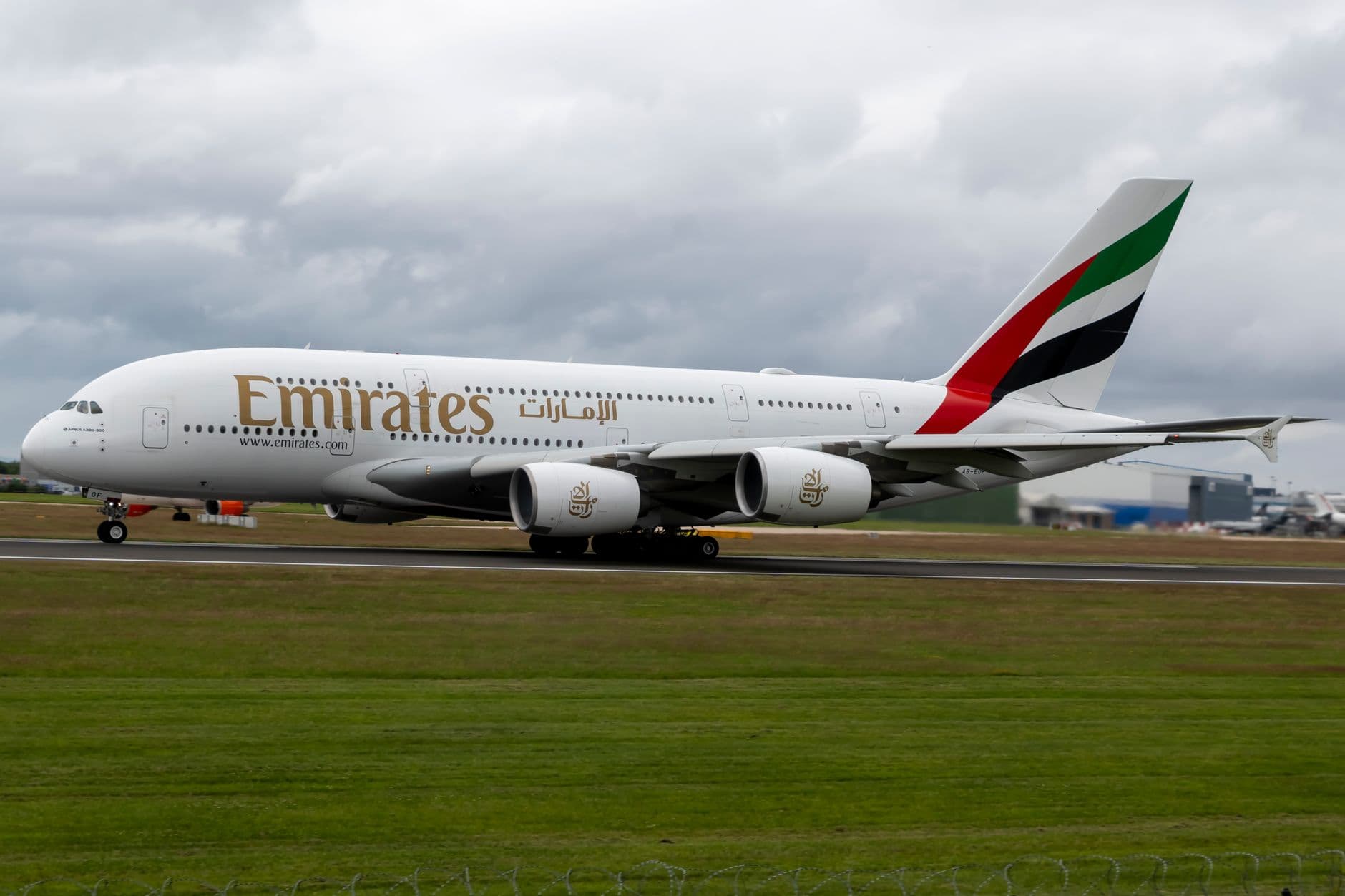 Side view of an Emirates Airbus A380 airplane taking off, showcasing its grandeur and design.